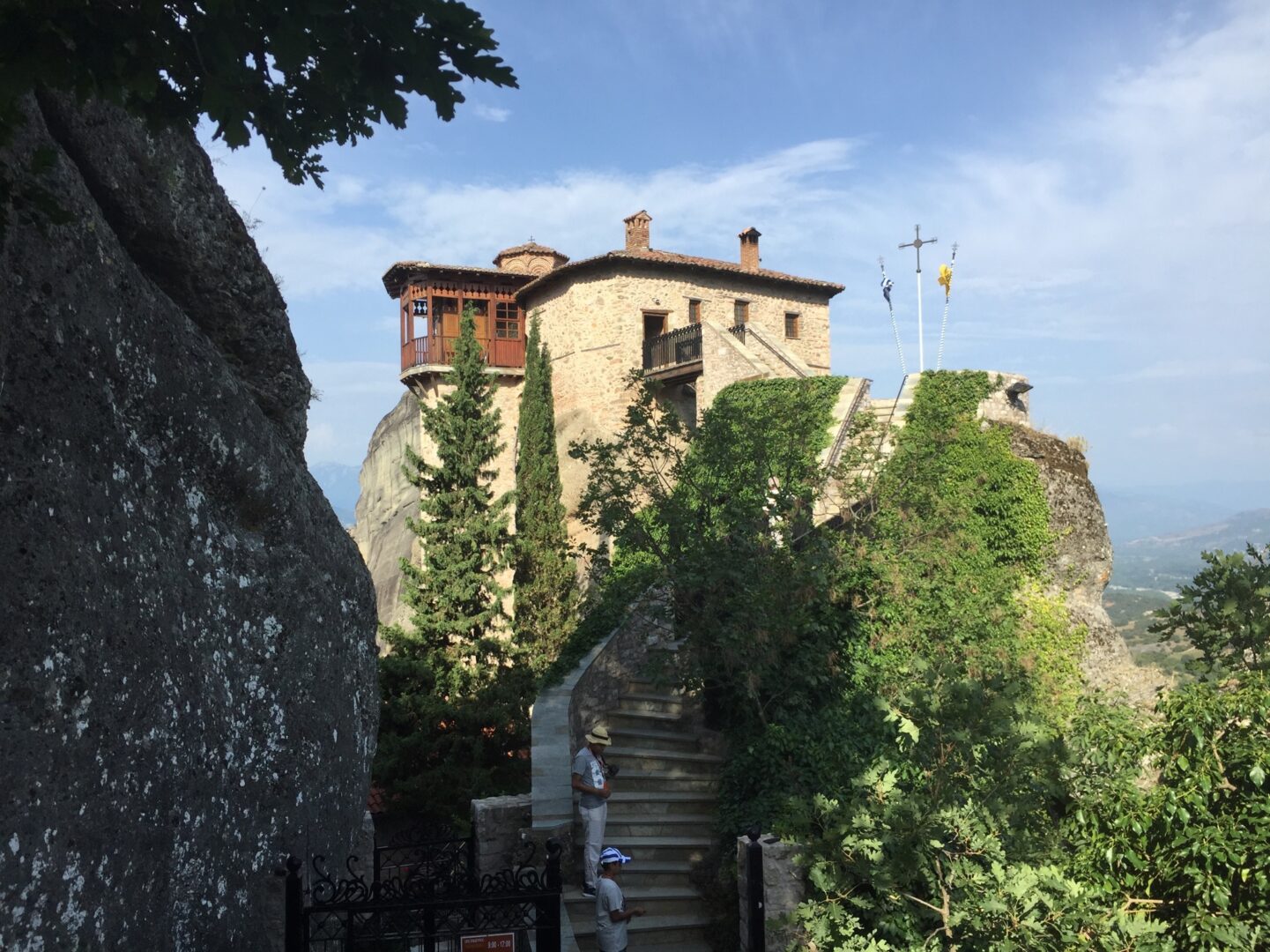 A house on top of a rock with stairs leading up to it.