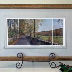 A framed print of four landscapes in a frame.