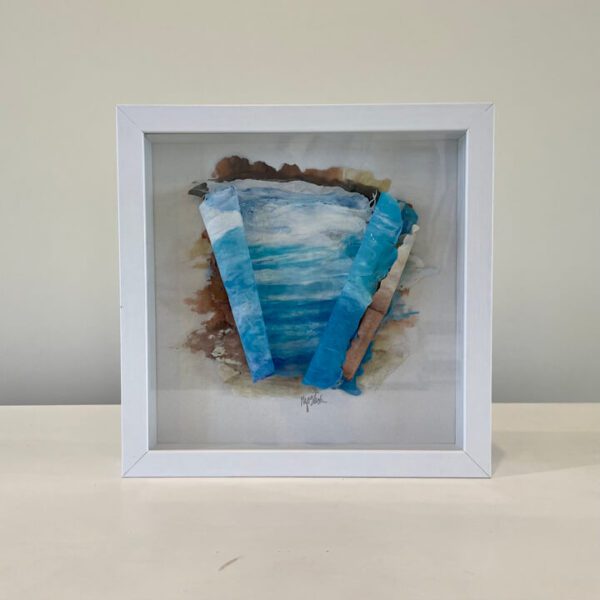 A white frame with a blue and white painting on it.